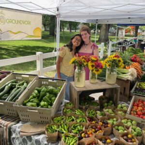 Food systems fellows working the farmers market booth in Paonia