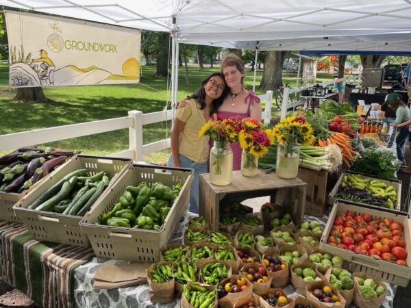 Food systems fellows working the farmers market booth in Paonia